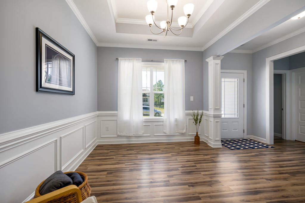 Spacious, elegant living room with a large window and modern decor elements.